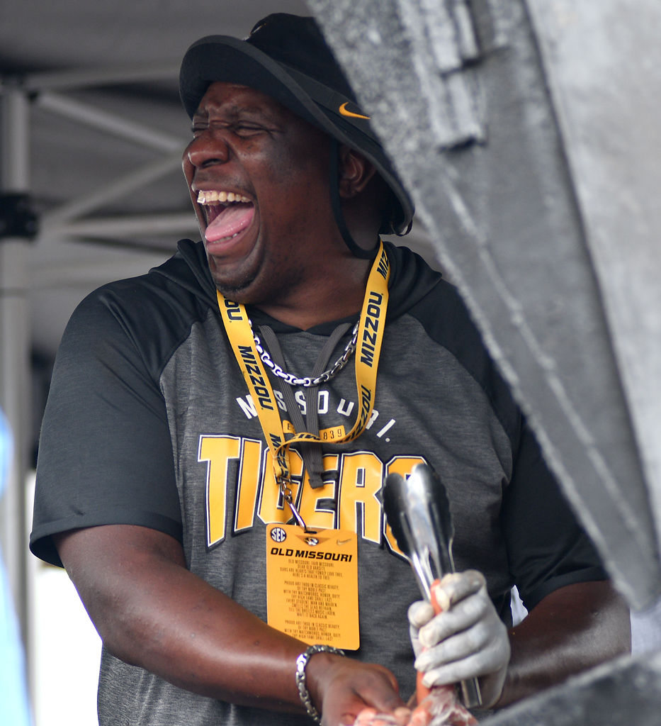 Gerald Nathan, Sr. grills food at the tailgate for MU football parents